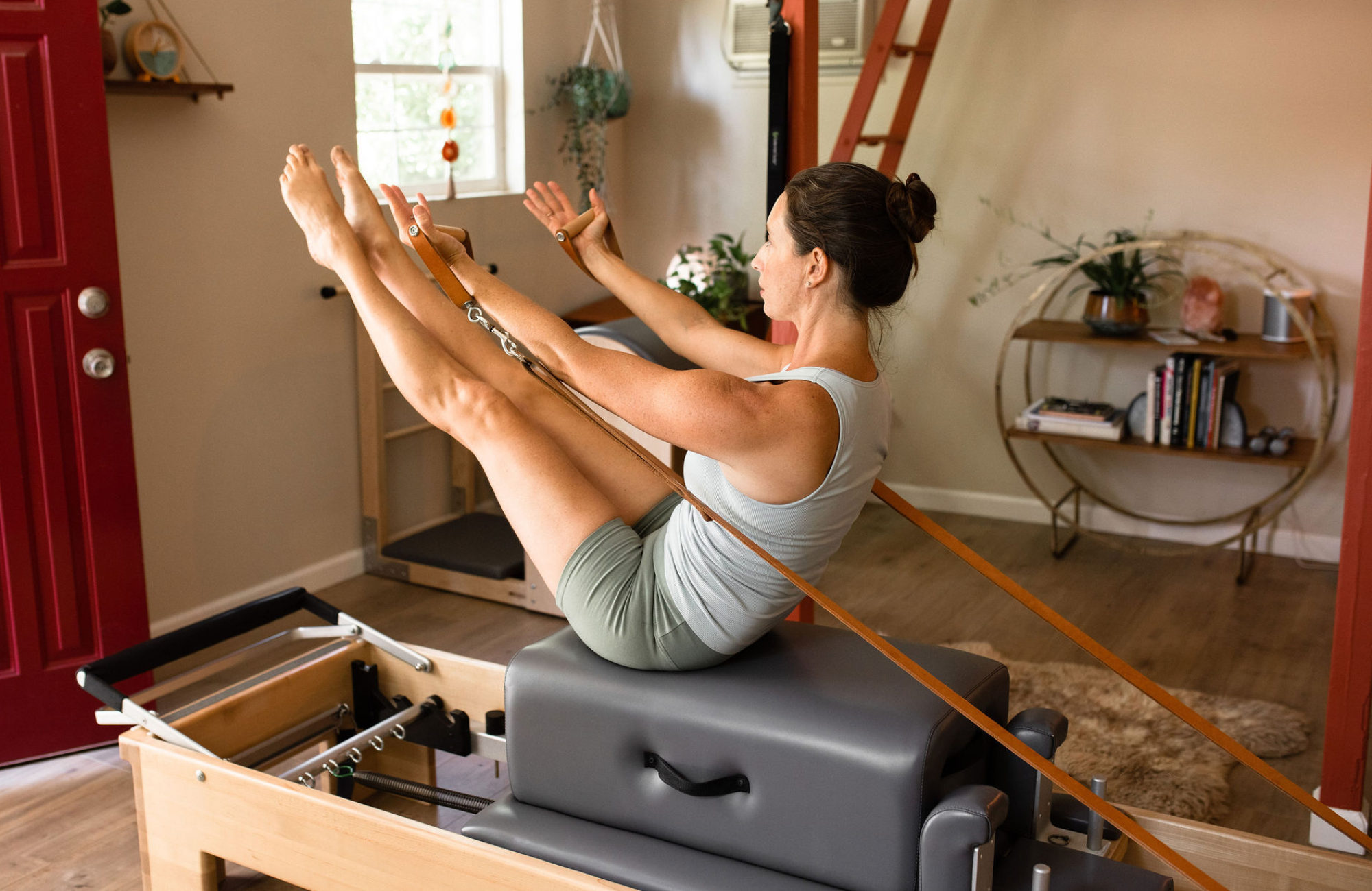Christmas practicing Pilates exercise Teaser on the Reformer